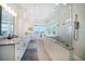 This spacious bathroom has a luxurious soaking tub with water views and a glass enclosed shower at 6976 S Shore S Dr, St Petersburg, FL 33707