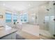 This spacious bathroom has a luxurious soaking tub with water views and a glass enclosed shower at 6976 S Shore S Dr, St Petersburg, FL 33707