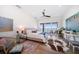 This bedroom features a ceiling fan, access to a deck, and a view of the water at 6976 S Shore S Dr, St Petersburg, FL 33707