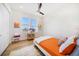 Bright bedroom with a ceiling fan, a comfortable bed, and serene views from the windows at 6976 S Shore S Dr, St Petersburg, FL 33707
