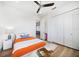 Bright bedroom boasts hardwood floors, ceiling fan, and spacious closet for ample storage at 6976 S Shore S Dr, St Petersburg, FL 33707