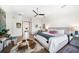 Spacious bedroom with ceiling fan, wooden floors, desk, and a luxurious rug at 6976 S Shore S Dr, St Petersburg, FL 33707