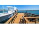 View of the boat dock with a boat lift and seating at 6976 S Shore S Dr, St Petersburg, FL 33707
