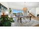 Dining room with contemporary table, chairs, and large sliding glass doors at 6976 S Shore S Dr, St Petersburg, FL 33707