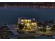 Beautiful waterfront home with balconies, lush landscaping, and a stunning view of the water at twilight at 6976 S Shore S Dr, St Petersburg, FL 33707