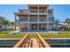 Stunning multi-level home featuring balconies, a backyard pool, and a private dock with canal access at 6976 S Shore S Dr, St Petersburg, FL 33707