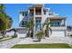 Modern two-story home with landscaped front yard, featuring a double garage and contemporary architectural design at 6976 S Shore S Dr, St Petersburg, FL 33707