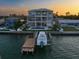 Exterior view of a multi-story waterfront home with a pool and boat dock at 6976 S Shore S Dr, St Petersburg, FL 33707