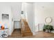 Bright foyer featuring a staircase with wood treads and a stylish metal railing at 6976 S Shore S Dr, St Petersburg, FL 33707