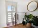 Bright foyer with modern finishes, decorative lighting, wood floors, and steel banister at 6976 S Shore S Dr, St Petersburg, FL 33707