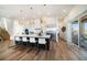 Open-concept kitchen with large island, modern appliances, stylish pendant lighting, and hardwood flooring at 6976 S Shore S Dr, St Petersburg, FL 33707