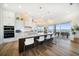 Modern, open kitchen with large island, seating, and stainless steel appliances with water views at 6976 S Shore S Dr, St Petersburg, FL 33707