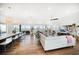 Spacious open-concept living area with hardwood floors and stunning waterfront views at 6976 S Shore S Dr, St Petersburg, FL 33707
