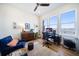 Sun-filled home office with a desk setup, comfortable seating, ceiling fan, area rug and lovely water view at 6976 S Shore S Dr, St Petersburg, FL 33707