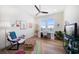 Bright office features large windows with water views, hardwood floors, and contemporary furnishings at 6976 S Shore S Dr, St Petersburg, FL 33707