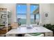 Bright white office desk offers water views from the window, great for a dedicated workspace at 6976 S Shore S Dr, St Petersburg, FL 33707