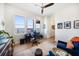 Office with wood floors, a desk setup, comfortable seating, ceiling fan, area rug and lovely water view at 6976 S Shore S Dr, St Petersburg, FL 33707
