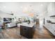 Expansive open floor plan featuring a kitchen island, dining area, and living room with seamless flow and bright lighting at 6976 S Shore S Dr, St Petersburg, FL 33707
