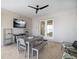 Inviting covered patio features an outdoor dining area and a ceiling fan at 6976 S Shore S Dr, St Petersburg, FL 33707