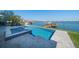 Gorgeous pool and hot tub with a dock extending to the serene water, perfect for relaxation at 6976 S Shore S Dr, St Petersburg, FL 33707