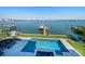 Waterfront home featuring a swimming pool, boat dock, and panoramic water views at 6976 S Shore S Dr, St Petersburg, FL 33707