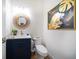 Chic powder room with navy vanity, modern fixtures, decorative mirror and stylish artwork at 6976 S Shore S Dr, St Petersburg, FL 33707