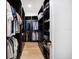Well-organized walk-in closet with shelving and hanging racks for efficient storage at 6976 S Shore S Dr, St Petersburg, FL 33707