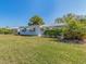 Exterior view of the house showing the surrounding trees, lawn and blue sky at 8622 140Th Way, Seminole, FL 33776