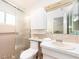 Well-lit bathroom with a sink, toilet, and shower enclosed by glass doors at 8622 140Th Way, Seminole, FL 33776