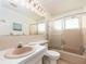 Bright bathroom featuring a shower over tub with sliding glass doors and a matching color scheme at 8622 140Th Way, Seminole, FL 33776