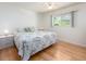 Bright bedroom with a large bed, side tables, and a window with a view at 8622 140Th Way, Seminole, FL 33776