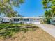 Charming single-story home with a well-maintained lawn and a white patterned privacy wall next to the front door at 8622 140Th Way, Seminole, FL 33776