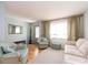 Inviting living room featuring hardwood floors, light green walls, and comfortable seating and a large window at 8622 140Th Way, Seminole, FL 33776