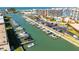 Aerial view of a waterfront community with boat docks, parking, and condo buildings at 1 Key Capri # 604W, Treasure Island, FL 33706