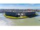 Aerial view features the condo building near manicured green spaces by the water at 1 Key Capri # 604W, Treasure Island, FL 33706