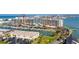 Aerial view showcasing waterfront condo buildings with docks, parking and ocean views at 1 Key Capri # 604W, Treasure Island, FL 33706