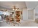 Cozy dining room featuring a wooden table set, ceiling fan, and a mirrored wall reflecting the adjacent living area at 1 Key Capri # 604W, Treasure Island, FL 33706