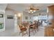 Dining room with a wooden table set for six with a mirrored wall reflecting bay views at 1 Key Capri # 604W, Treasure Island, FL 33706