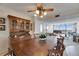 Inviting dining area flows into the living room with views, featuring a wooden table, china cabinet, and elegant ceiling fan at 1 Key Capri # 604W, Treasure Island, FL 33706
