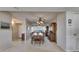Bright dining room with a classic wooden table, hutch, ceiling fan, and an expansive view reflected in the mirrored wall at 1 Key Capri # 604W, Treasure Island, FL 33706