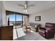 Cozy living room features a recliner, dresser, sofa, and balcony access with scenic views at 1 Key Capri # 604W, Treasure Island, FL 33706