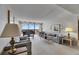 Bright living room featuring a piano, comfortable seating, and large windows with scenic views at 1 Key Capri # 604W, Treasure Island, FL 33706