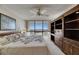 Bright main bedroom with custom built-ins, ceiling fan, and a large window showcasing the view at 1 Key Capri # 604W, Treasure Island, FL 33706