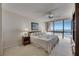 Inviting bedroom offering a comfortable bed, nightstands, and large windows with scenic views at 1 Key Capri # 604W, Treasure Island, FL 33706