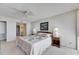 Cozy main bedroom with soft carpeting, a ceiling fan, and access to the en suite bathroom at 1 Key Capri # 604W, Treasure Island, FL 33706