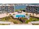 Aerial view of a sparkling blue pool and hot tub with lounge chairs near the intercoastal waterway at 1 Key Capri # 604W, Treasure Island, FL 33706