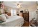 Inviting bedroom with hardwood floors, a ceiling fan, and multiple dressers, creating a peaceful retreat at 10017 Courtney Palms Blvd # 301, Tampa, FL 33619
