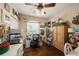 Cozy bedroom with a ceiling fan, hardwood floors, and a bright window, ideal for a home office or craft space at 10017 Courtney Palms Blvd # 301, Tampa, FL 33619