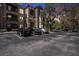 Multi-story condo building with stone facade and parking lot at dusk at 10017 Courtney Palms Blvd # 301, Tampa, FL 33619