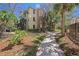 Beautiful condo exterior featuring lush landscaping and a stone-accented facade at 10017 Courtney Palms Blvd # 301, Tampa, FL 33619